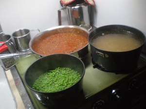 Apropos of nothing, I include this shot of a recent meal, cooking on the Tramper stove. The pots on the front burner are part of a set given us by Alex and Daria. We use something of the set every day!